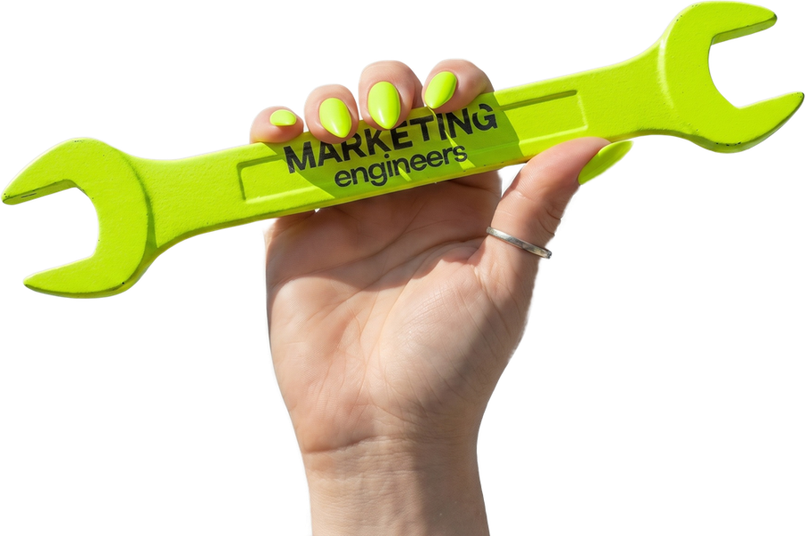 Mary-Anne's hand holding the neon Marketing Engineers spanner